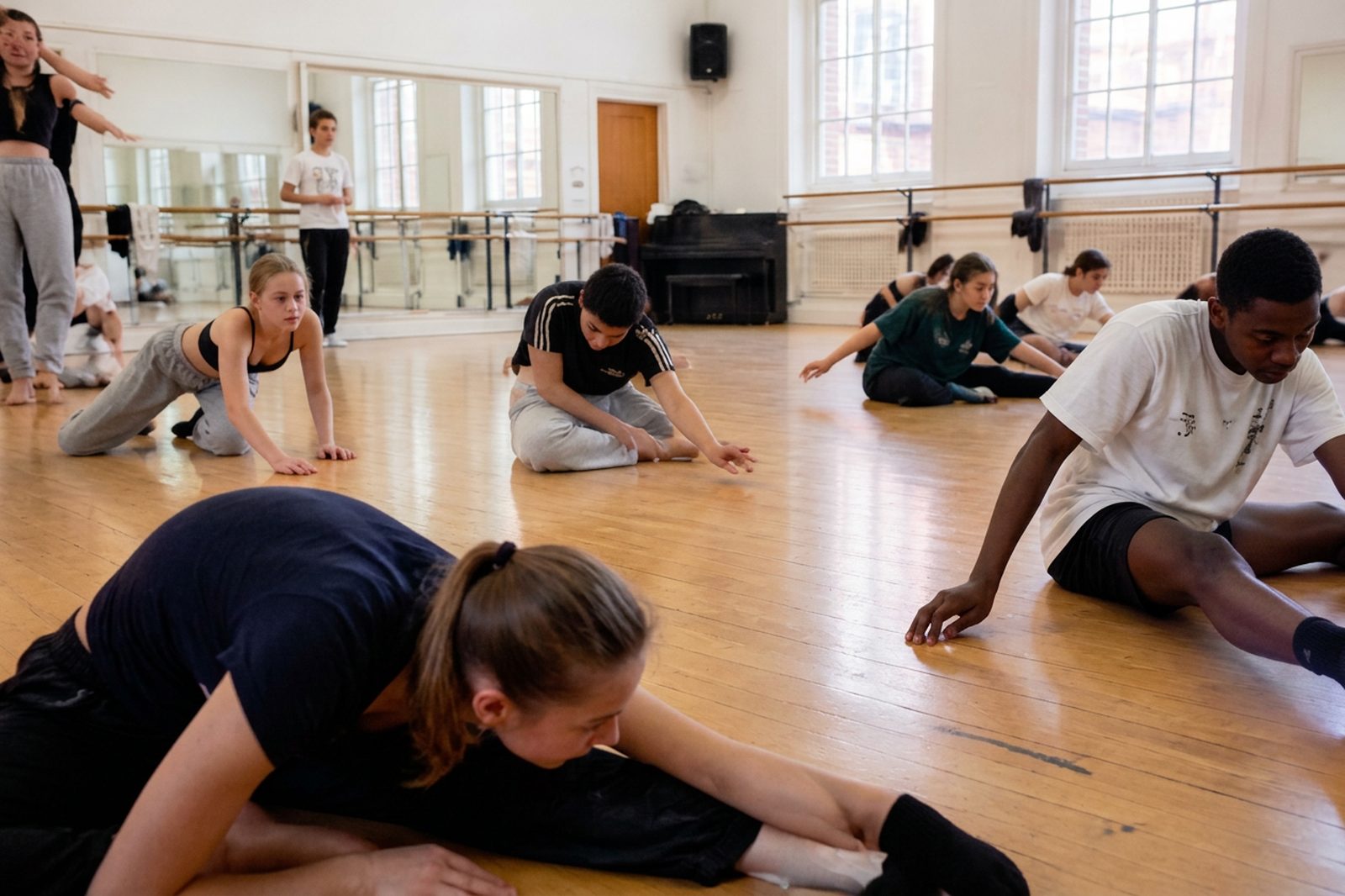Young performers rehearsing together in a UK dance studio